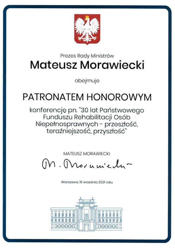 Image of the certificate informing about the honorary patronage of the conference entitled "30 years of the State Fund for Rehabilitation of Disabled People". At the top, on a white background, the emblem of Poland, below, a handwritten signature of the Prime Minister of the Republic of Poland, Mateusz Morawiecki. At the bottom, a picture of the building of the Chancellery of the Prime Minister.